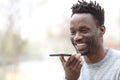 Happy black man using voice recognition on phone Royalty Free Stock Photo