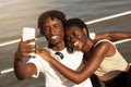 Happy Black Millennial Couple Taking Selfie On Smartphone While Doing Sport Outdoors Royalty Free Stock Photo