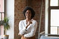 Happy Black millennial entrepreneur woman posing in contemporary loft space Royalty Free Stock Photo