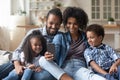 Happy parents and cute sibling kids watching online media content Royalty Free Stock Photo