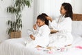 Happy Black Mom Her Daughter In Bathrobes Playing Beauty Salon At Home Royalty Free Stock Photo