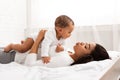 Happy Black Mommy Playing With Baby Lying In Bedroom Royalty Free Stock Photo