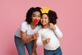 Happy black mother and her daughter posing with paper party accessories Royalty Free Stock Photo