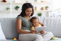 Happy Black Mother And Infant Baby Relaxing With Digital Tablet At Home Royalty Free Stock Photo