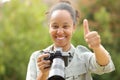 Happy black photographer with thumbs up Royalty Free Stock Photo