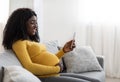 Happy black pregnant woman holding mobile phone Royalty Free Stock Photo