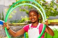 Happy black smiling girl with hula hoop rings