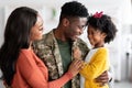 Happy Black Soldier Man Embracing With Wife And Little Daughter At Home Royalty Free Stock Photo