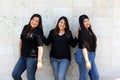 Happy black straight hair latin adult sisters dressed in black for family photo shoot in harmony and joy Royalty Free Stock Photo