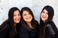 Happy black straight hair latin adult sisters dressed in black for family photo shoot in harmony and joy Royalty Free Stock Photo