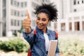 Happy Black Student Girl Gesturing Thumbs-Up Near University Building Outdoors Royalty Free Stock Photo