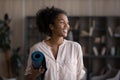 Happy Black teen girl holding rolled yoga mat Royalty Free Stock Photo