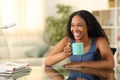 Happy black woman drinking coffee at home Royalty Free Stock Photo