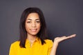 Happy black woman with empty open hand for advertising marketing or product placement posing and smiling