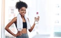 Happy, black woman and fitness with water and towel after cardio training or practice for wellness. Young, female person Royalty Free Stock Photo