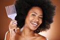 Happy black woman, hair care and comb in portrait with afro pick, beauty and self care by brown backdrop. African woman Royalty Free Stock Photo