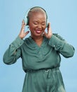 Happy black woman, headphones and dancing to music, audio track or sound against a studio background. African female Royalty Free Stock Photo