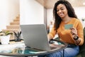 Happy black woman holding debit credit card, using computer Royalty Free Stock Photo