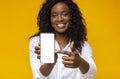 Happy black woman holding latest slim smartphone