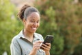 Happy black woman holding phone looking at camera Royalty Free Stock Photo