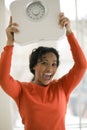 Happy Black woman holding scale Royalty Free Stock Photo