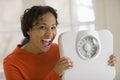 Happy black woman holding scale Royalty Free Stock Photo