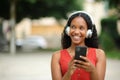 Happy black woman looking at side listening music Royalty Free Stock Photo