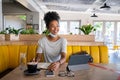 Happy black woman with lowered mask looking away