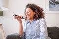 Happy black woman making a phone call using voice notes