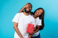 Happy black woman making surprise for her boyfriend giving box Royalty Free Stock Photo
