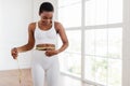 Happy Black Woman Measuring Waist With Tape. Dieting Slimming Concept Royalty Free Stock Photo