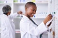 Happy black woman, pharmacist and pills for inventory inspection or checking stock on shelf at pharmacy. African female Royalty Free Stock Photo