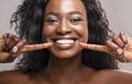 Happy black woman pointing at her perfect white teeth Royalty Free Stock Photo