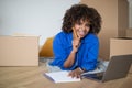 Happy Black Woman Relaxing With Laptop Among Cardboard Boxes After Moving Home Royalty Free Stock Photo