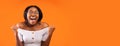 Happy Black Woman Screaming Shaking Fists Standing, Orange Background, Panorama