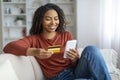 Happy Black Woman Shopping Online With Smartphone And Credit Card At Home Royalty Free Stock Photo