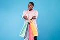 Happy Black Woman Showing Paper Shopper Bags Over Blue Background Royalty Free Stock Photo