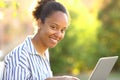 Happy black woman using laptop looking at you Royalty Free Stock Photo