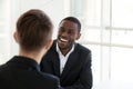 Happy black worker smiling having talk with colleague Royalty Free Stock Photo