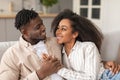 Happy black young couple cuddling sharing embrace in living room Royalty Free Stock Photo