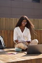 Happy African girl student elearning using laptop studying outside. Royalty Free Stock Photo