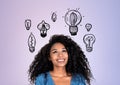 Happy black young woman and set of lightbulbs on lilac background Royalty Free Stock Photo