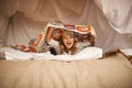 Happy, blanket fort and portrait of child relaxing and playing hide and seek with quilt at home. Excited, smile and face Royalty Free Stock Photo
