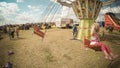 Happy blond baby girl in a chains carousel country fair in Romania