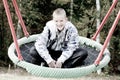 Happy blond boy in the swing Royalty Free Stock Photo