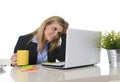 Happy blond business woman working on computer at office desk smiling Royalty Free Stock Photo
