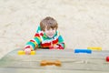 Happy blond kid boy having fun and climbing on outdoor playground Royalty Free Stock Photo