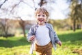 Happy toddler boy running outside in spring nature. Royalty Free Stock Photo