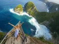 Happy blond tourist woman feeling free on the stunning view of beautiful sea cliff beach at viewpoint enjoying exotic Summer Royalty Free Stock Photo