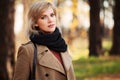 Happy blond fashion woman walking in autumn forest